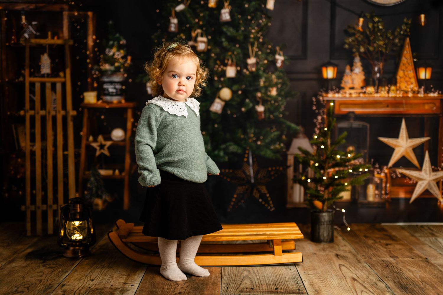 Festive holiday scene with wooden sled and Christmas decorations in cozy indoor setting.
