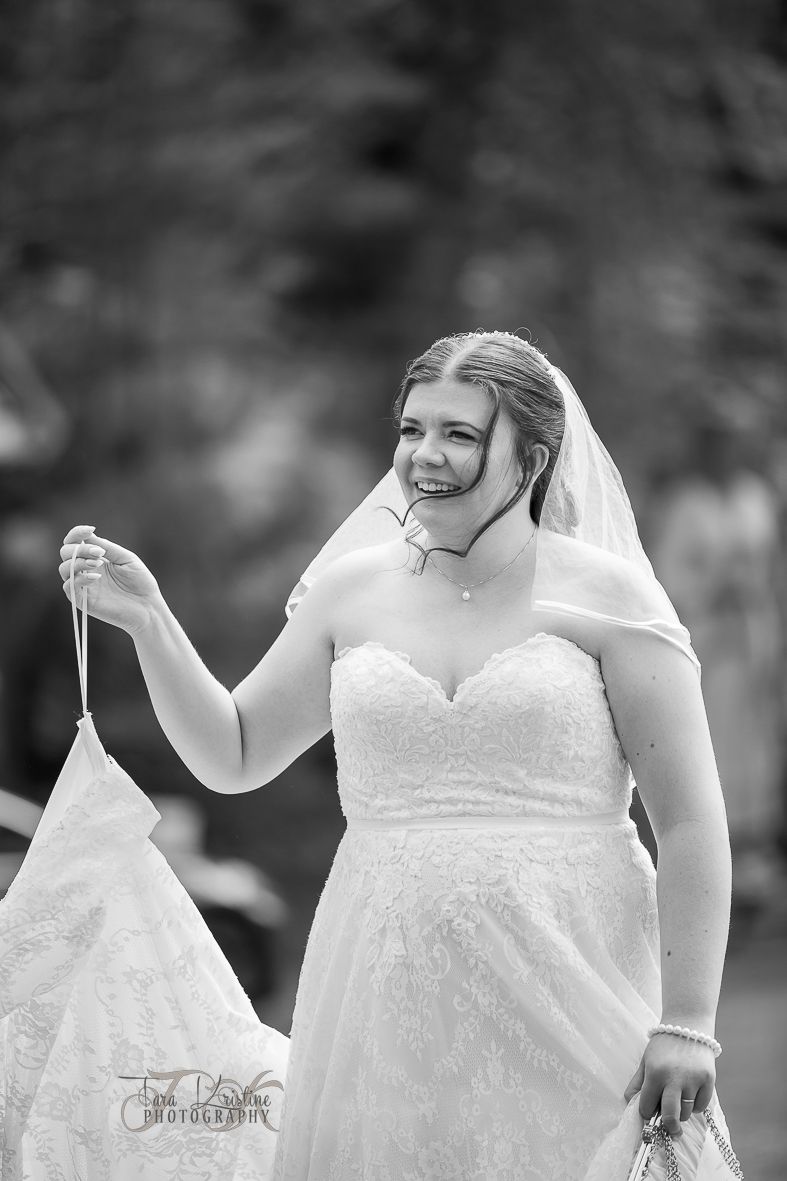 Close-up details of a white lace wedding dress with delicate patterns.