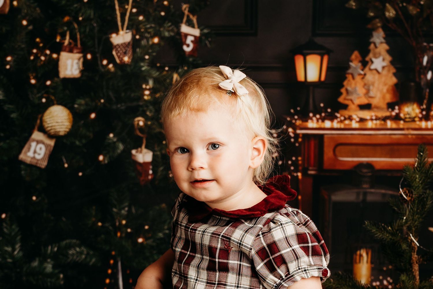 Holiday themed photoshoot with rustic Christmas decor and twinkling lights.