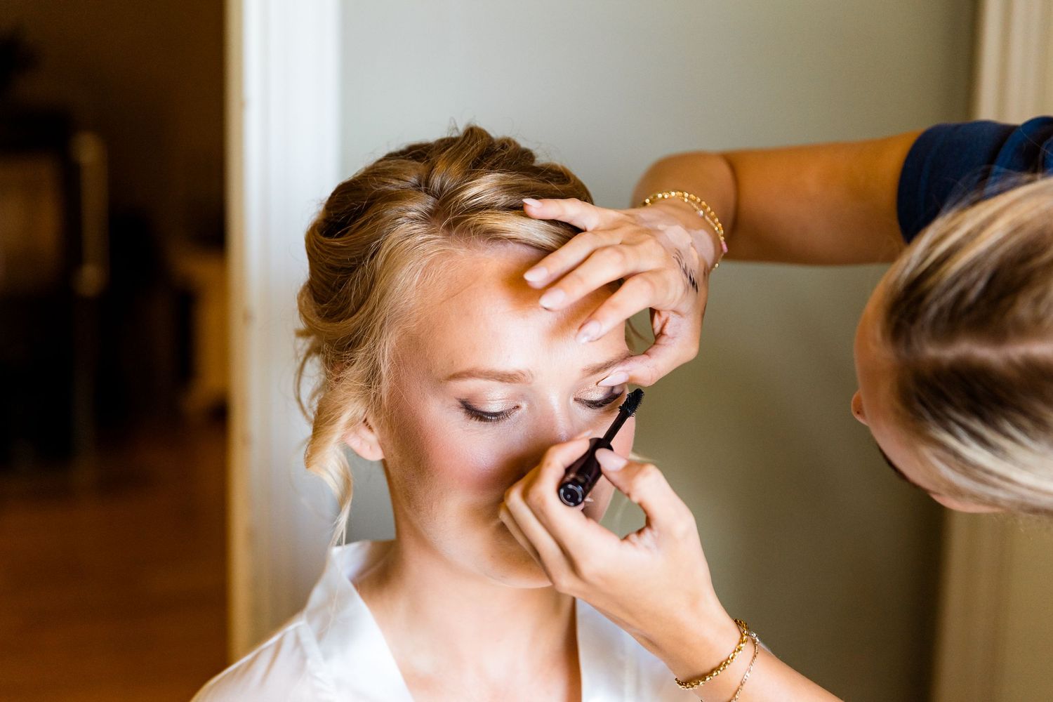 Wedding day makeup application and styling preparation.