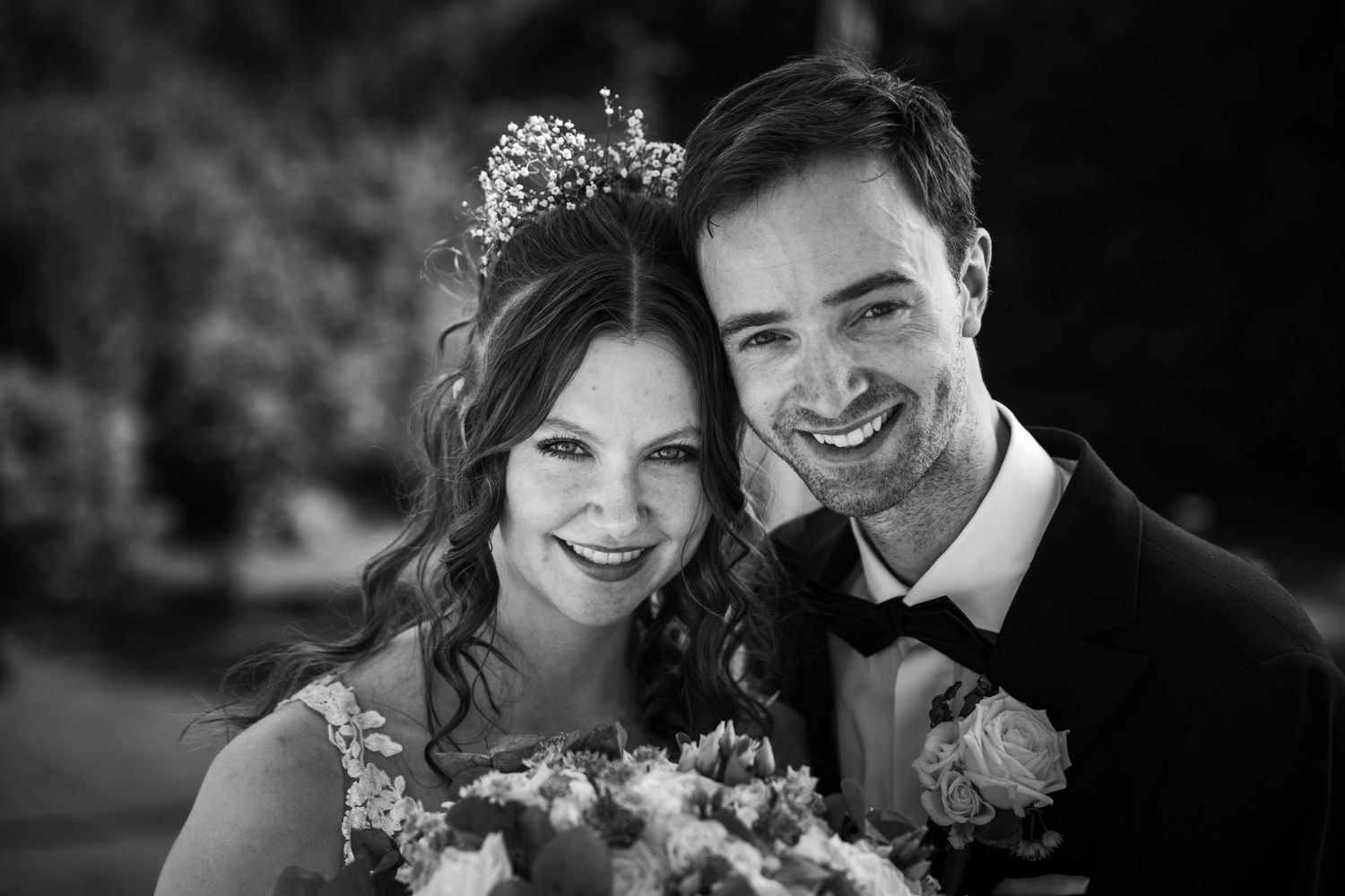 Black and white wedding portrait showing a romantic close-up moment.