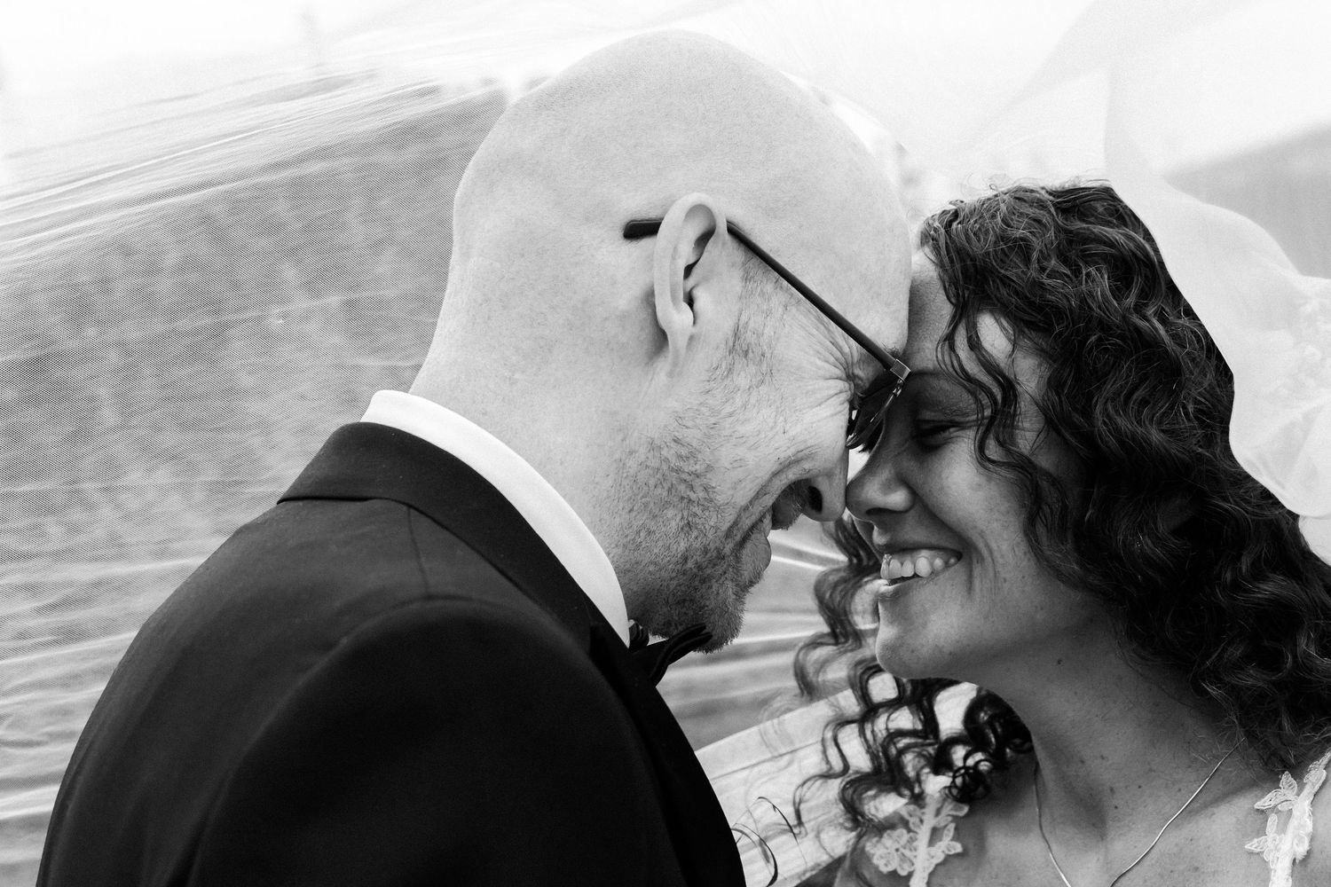 Black and white close-up of romantic wedding couple moment.