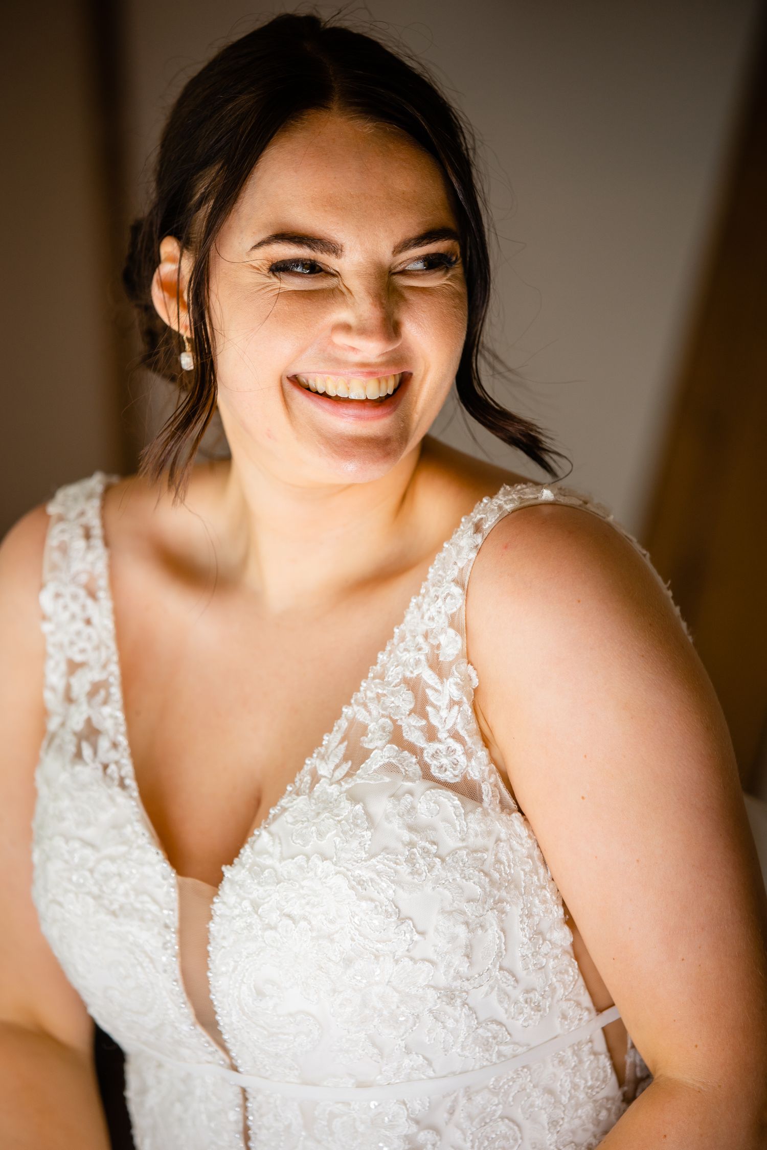 Close-up details of a white lace wedding dress bodice with delicate floral patterns.