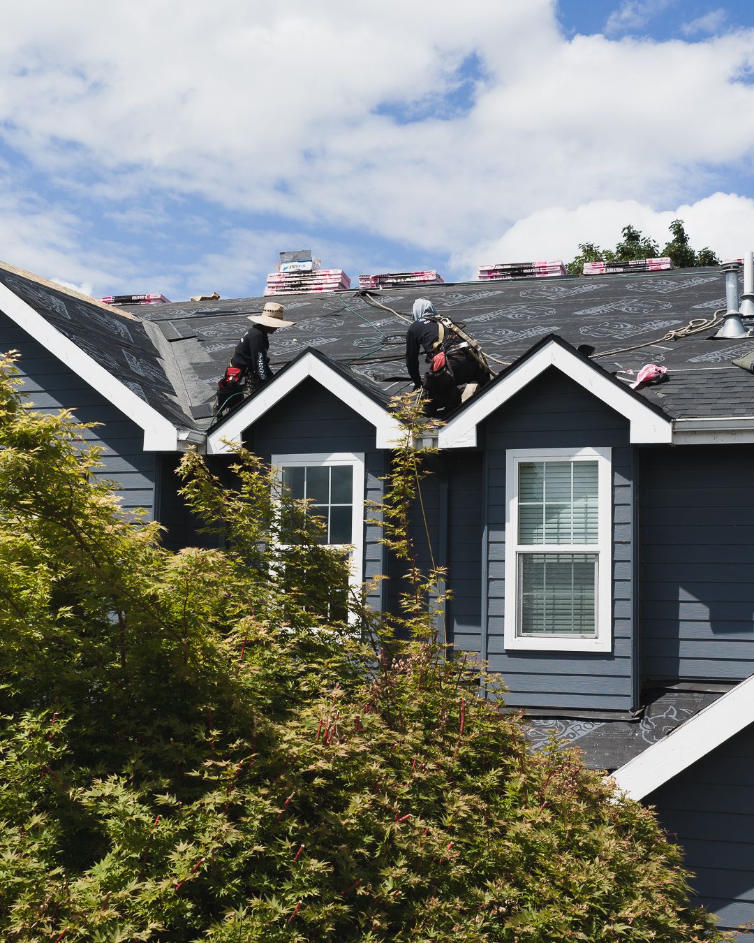 Roofing crew working on a home for Sharks Roofing in Eugene, Oregon.
