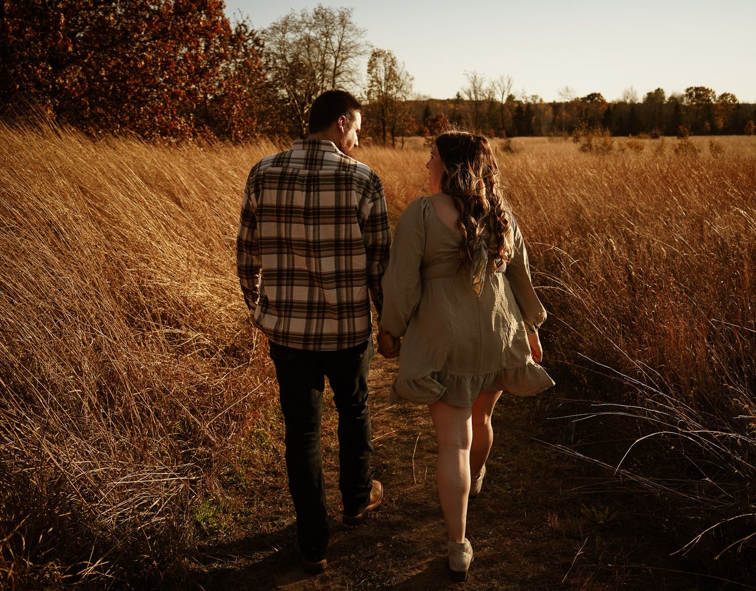 Wisconsin Couple and Engagement Photographer - Couple in a field in fall during an engagement session in Wisconsin during sunset.