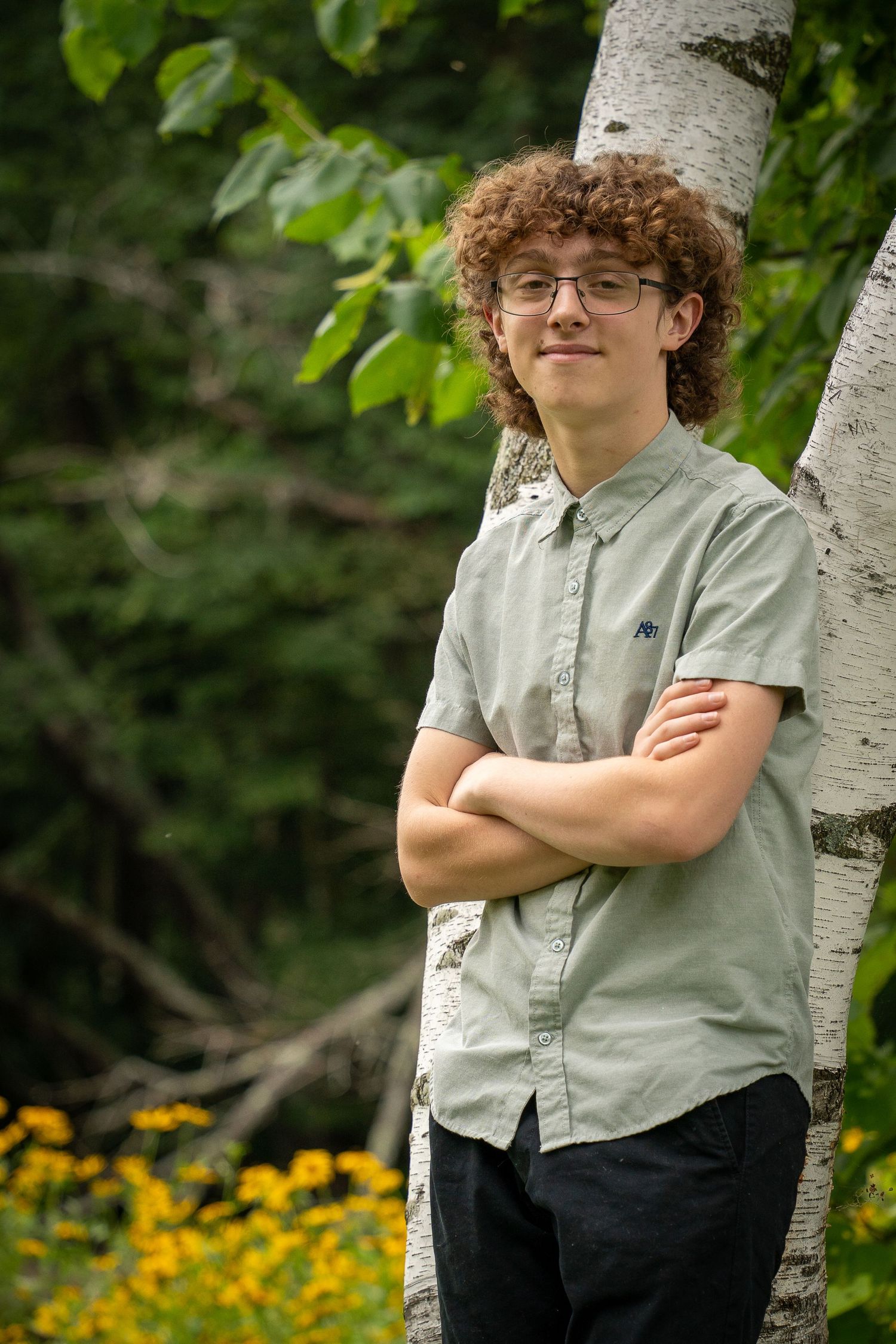 Wisconsin Senior and Portrait Photographer - Boy smiling next to birch trees in Wisconsin during a summer senior portrait session.