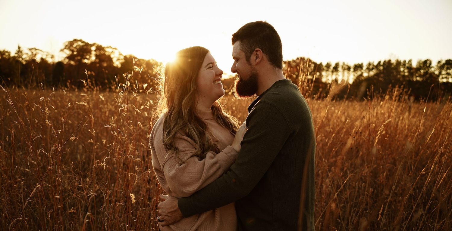 Wisconsin Couple and Engagement Photographer - Couple in a field in fall during an engagement session in Wisconsin during sunset.