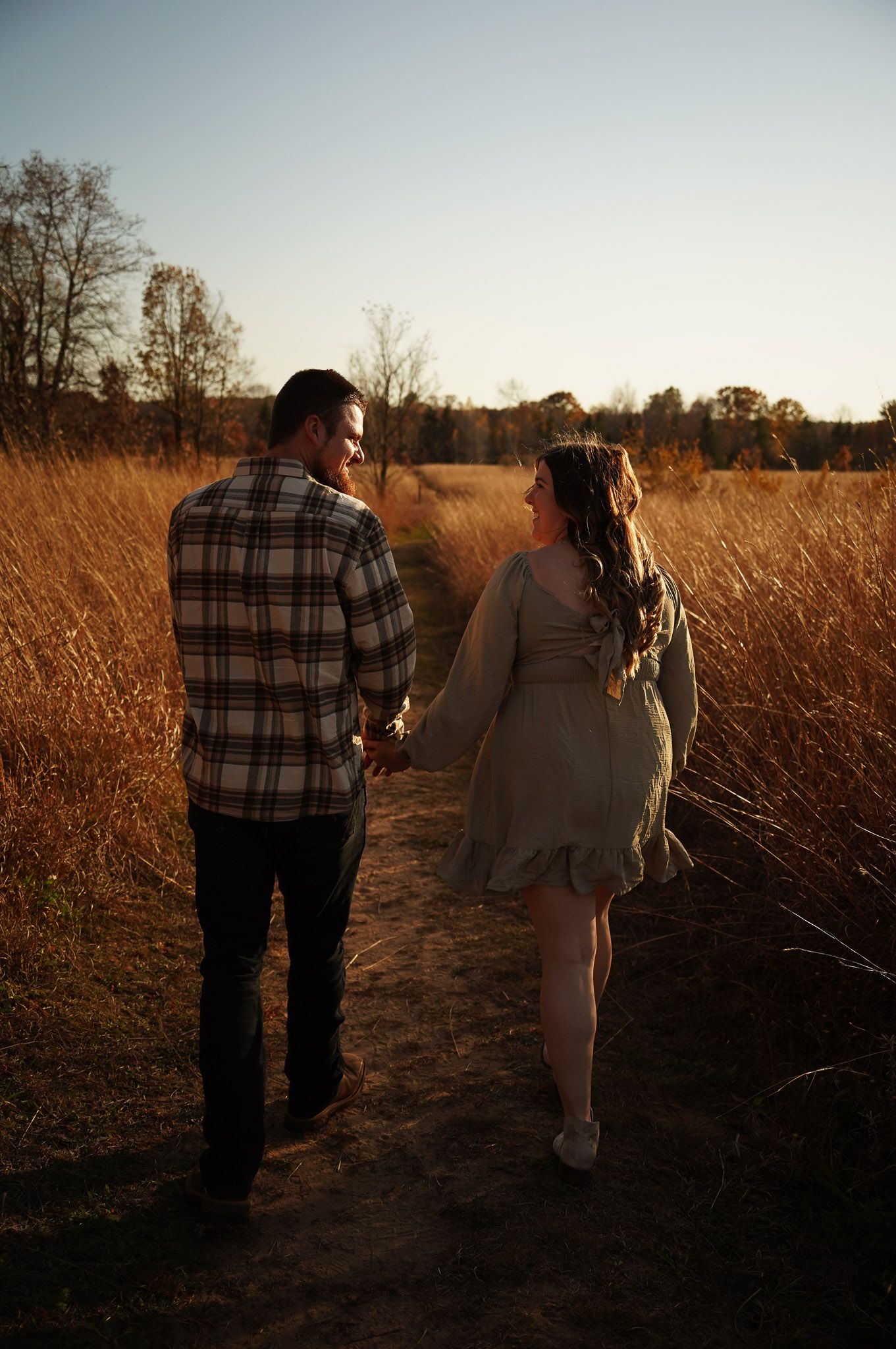 Wisconsin Couple and Engagement Photographer - Couple in a field in fall during an engagement session in Wisconsin during sunset.