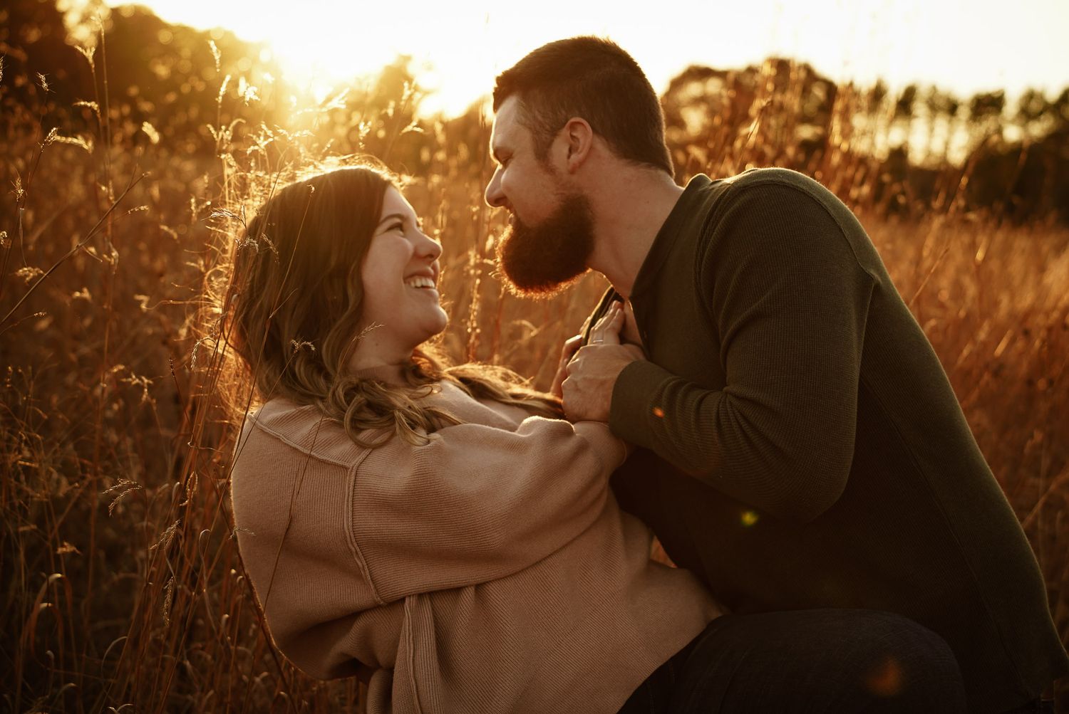 Wisconsin Couple and Engagement Photographer - Couple in a field in fall during an engagement session in Wisconsin during sunset.
