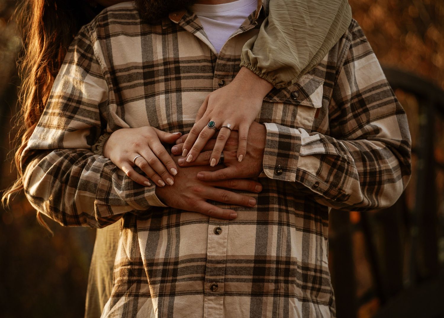 Wisconsin Couple and Engagement Photographer - Detailed photo of hands and engagement ring with plaid shirt in fall during sunset in Wisco.