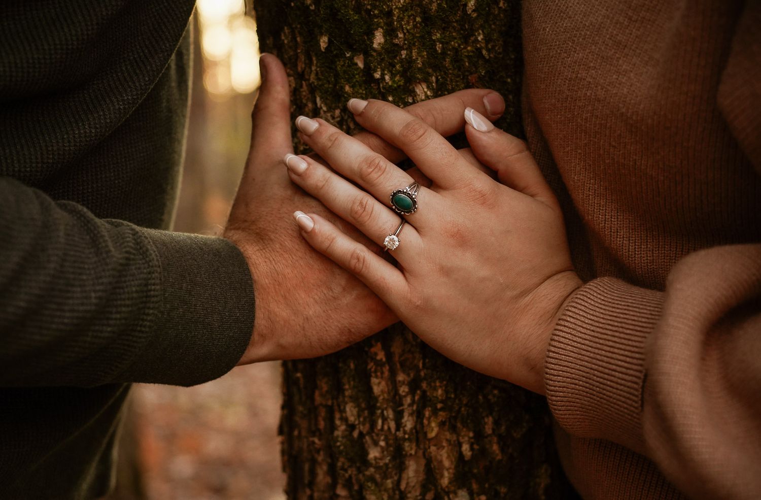 Wisconsin Couple and Engagement Photographer - Beautiful engagement ring photo with couples hands touching on tree in woods in Wisconsin.