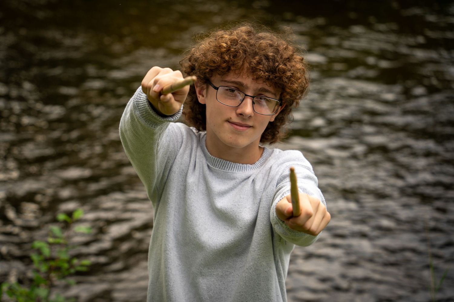 Wisconsin Senior and Portrait Photographer - Drummer senior boy smiling holding drumsticks in Wisconsin during a summer senior portrait.