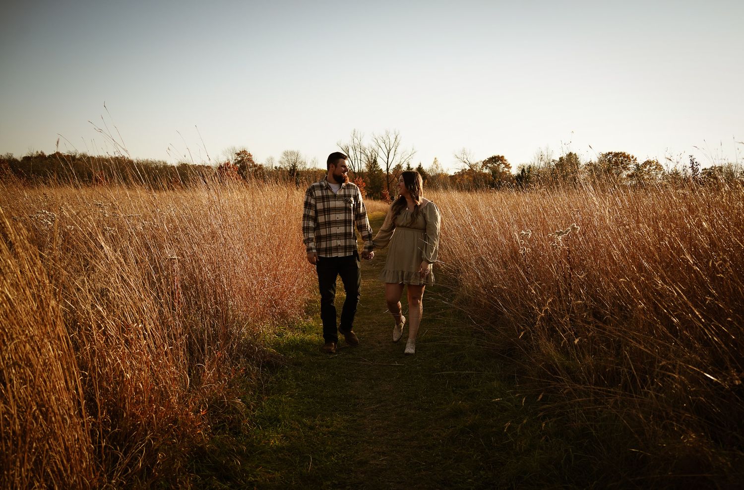 Wisconsin Couple and Engagement Photographer - Couple in a field in fall during an engagement session in Wisconsin during sunset.