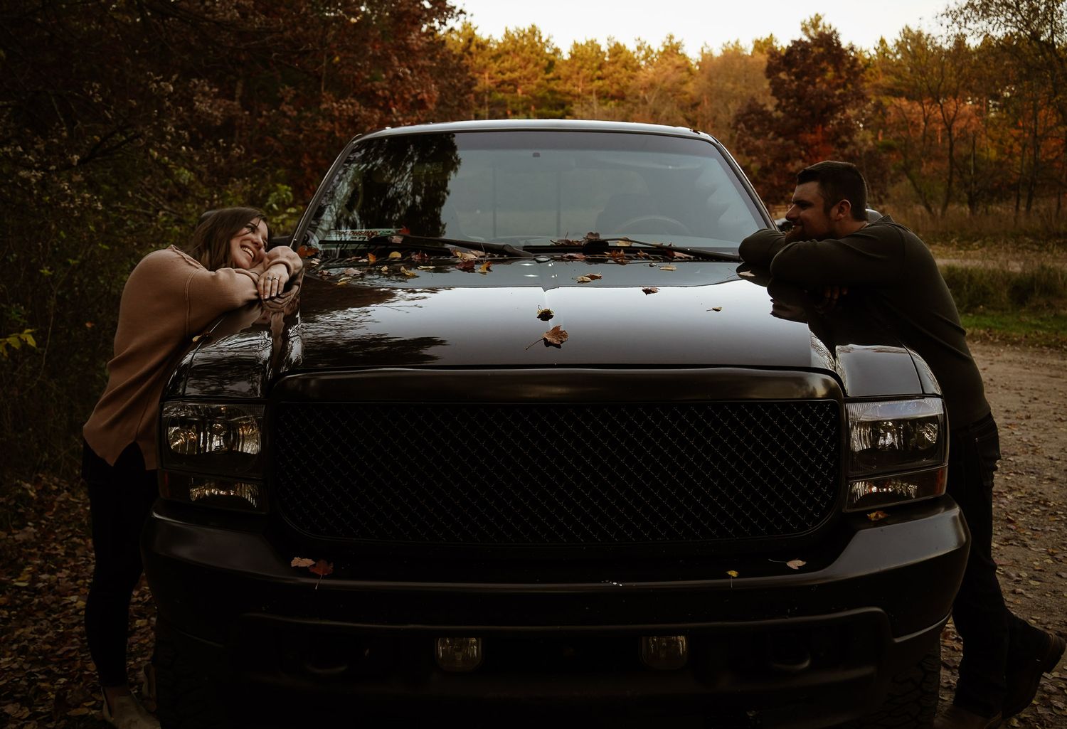 Wisconsin Couple and Engagement Photographer - Sunset photo of couple silhouette during engagement session with a trucks in a field.