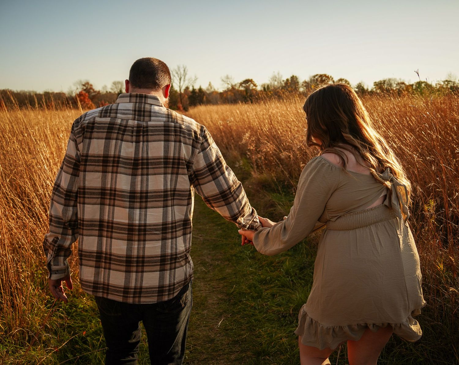 Wisconsin Couple and Engagement Photographer - Couple in a field in fall during an engagement session in Wisconsin during sunset.