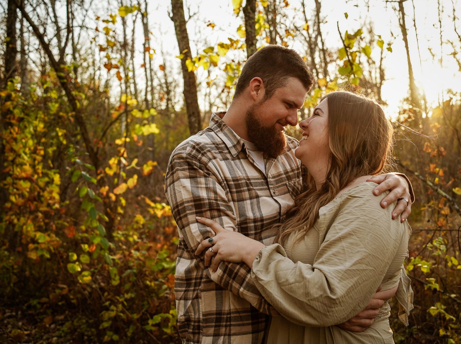 Wisconsin Couple and Engagement Photographer - Couple in woods in fall during an engagement session during sunset in Wisconsin.