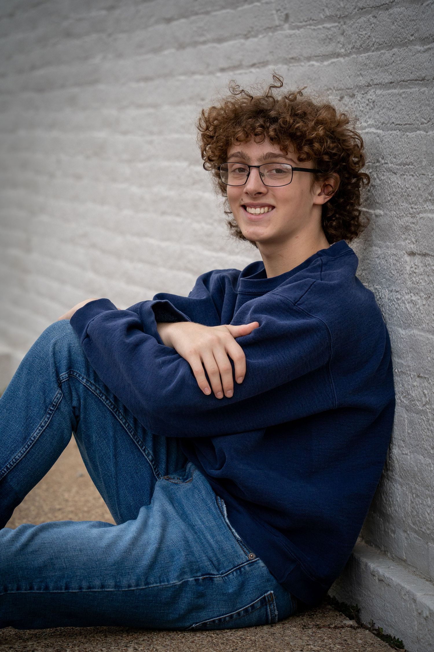 Wisconsin Senior and Portrait Photographer - Boy leaning on brick wall in the city in Wisconsin during a summer senior portrait session.