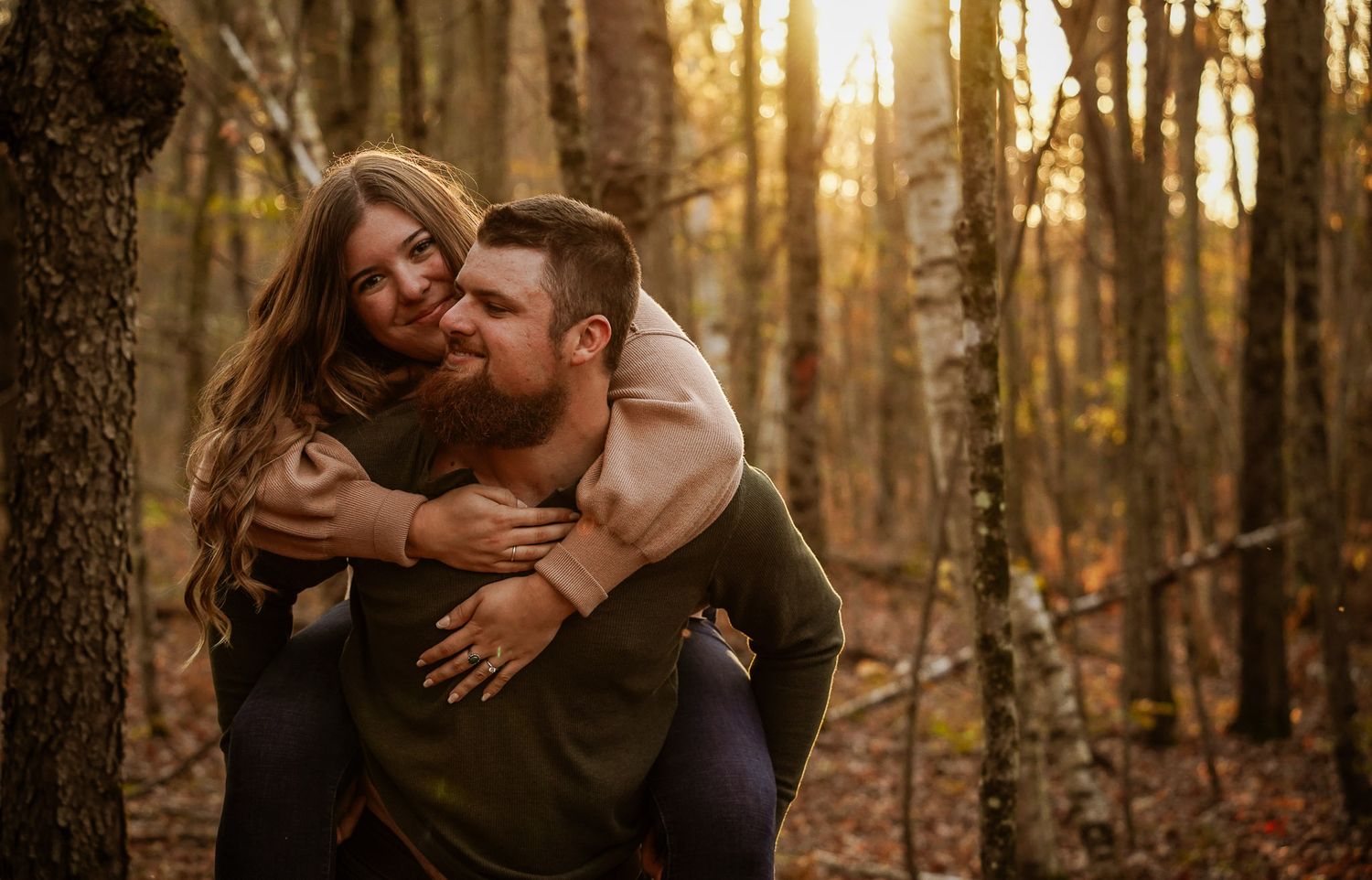 Wisconsin Couple and Engagement Photographer - Couple laughing in woods in fall during an engagement session during sunset in Wisconsin.