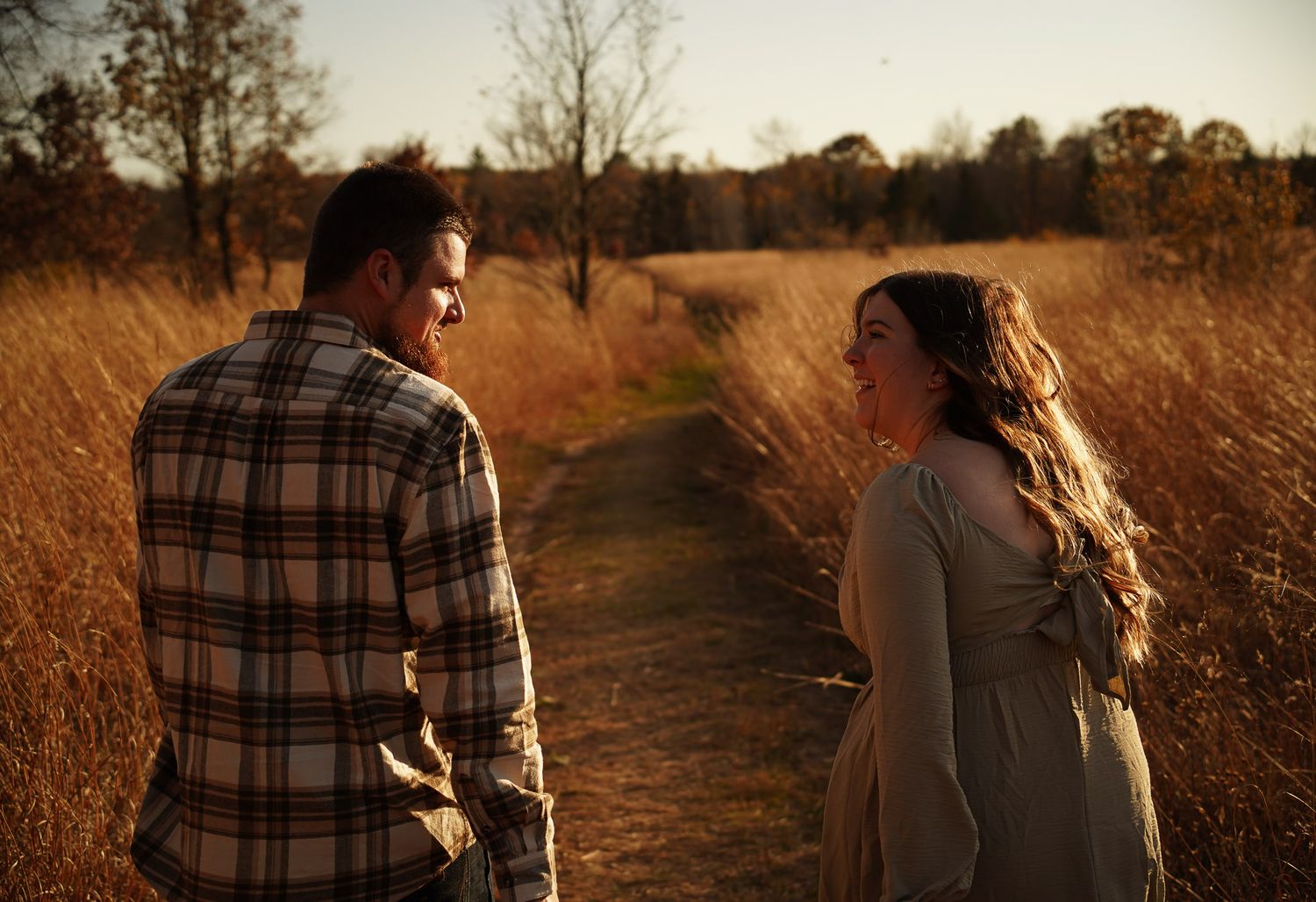 Wisconsin Couple and Engagement Photographer - Couple in a field in fall during an engagement session in Wisconsin during sunset.