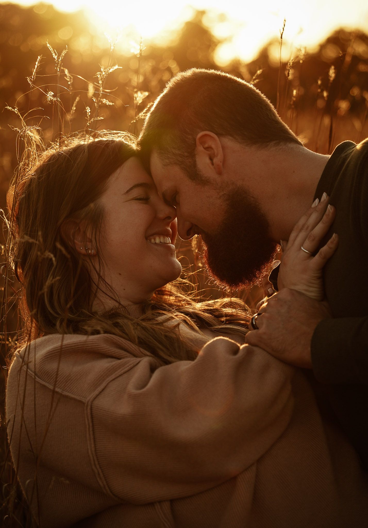 Wisconsin Couple and Engagement Photographer - Couple in a field in fall during an engagement session in Wisconsin during sunset.