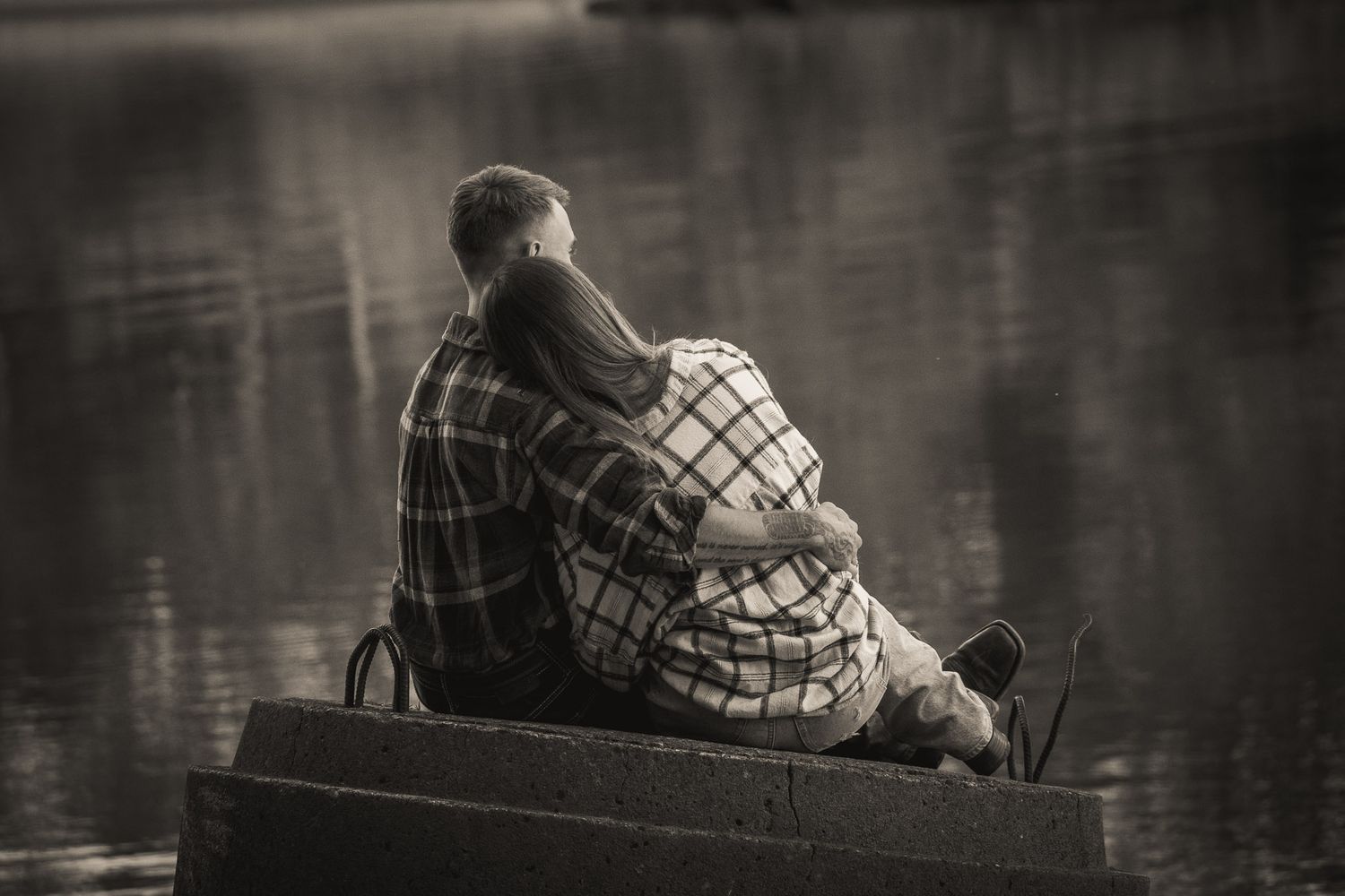Wisconsin Couple and Engagement Photographer - Black and white couple on riverbank in Wisconsin in fall during engagement session.