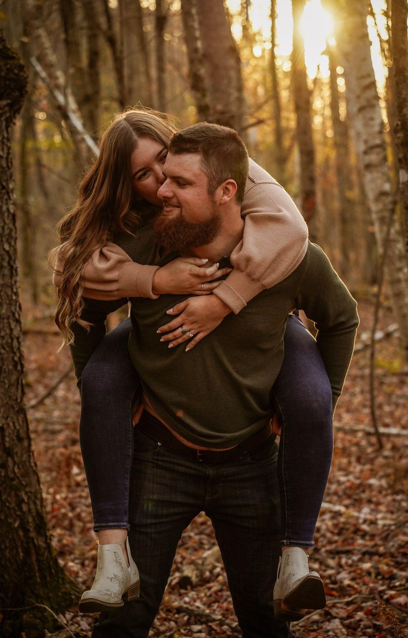 Wisconsin Couple and Engagement Photographer - Couple laughing in woods in fall during an engagement session during sunset in Wisconsin.