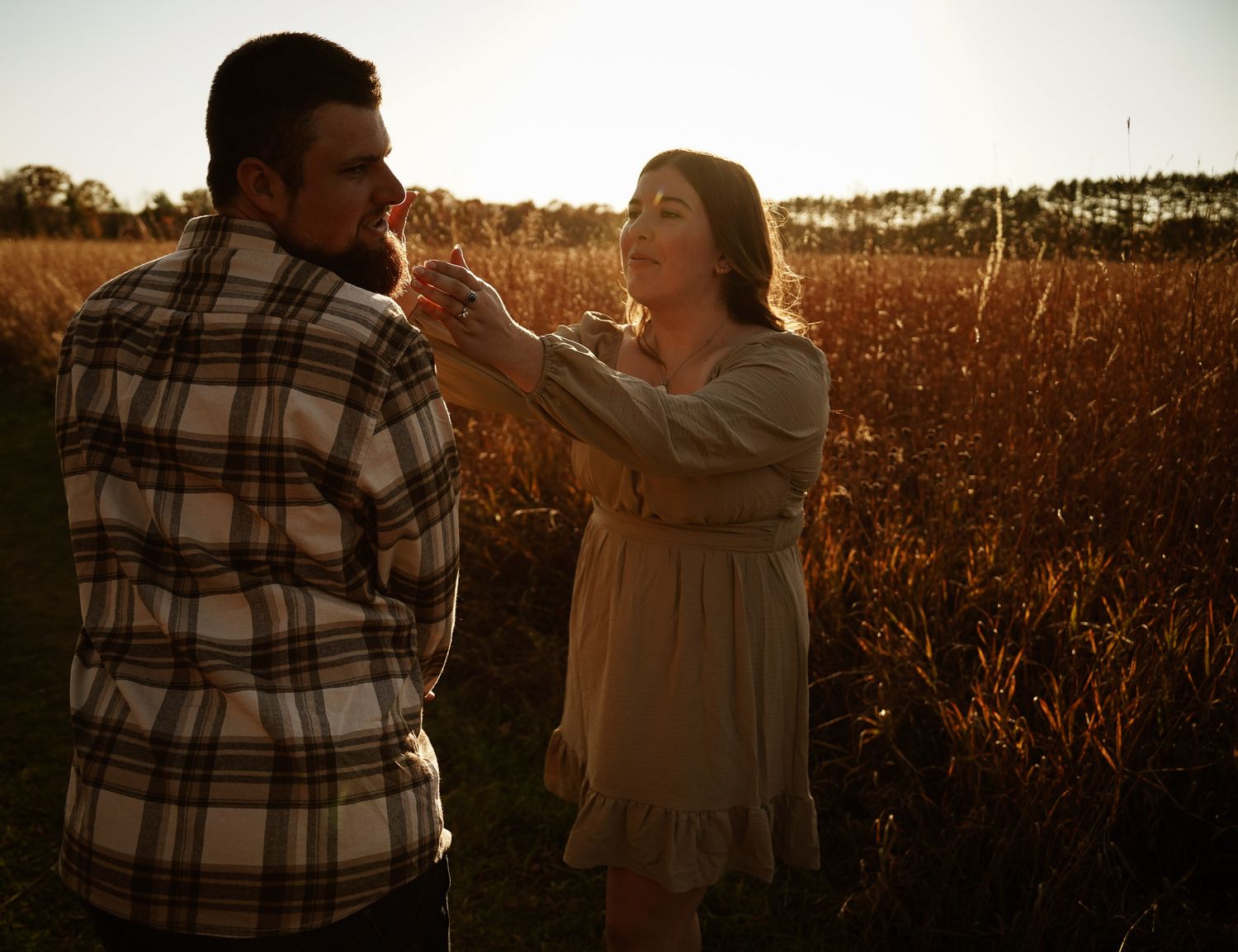 Wisconsin Couple and Engagement Photographer - Couple in a field in fall during an engagement session in Wisconsin during sunset.