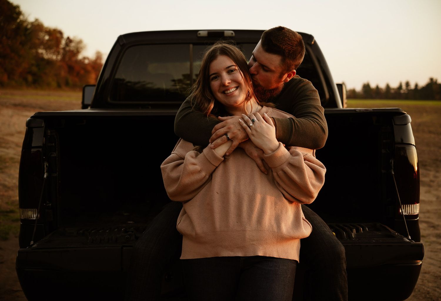 Wisconsin Couple and Engagement Photographer - Sunset photo of couple silhouette during engagement session with a trucks in a field.