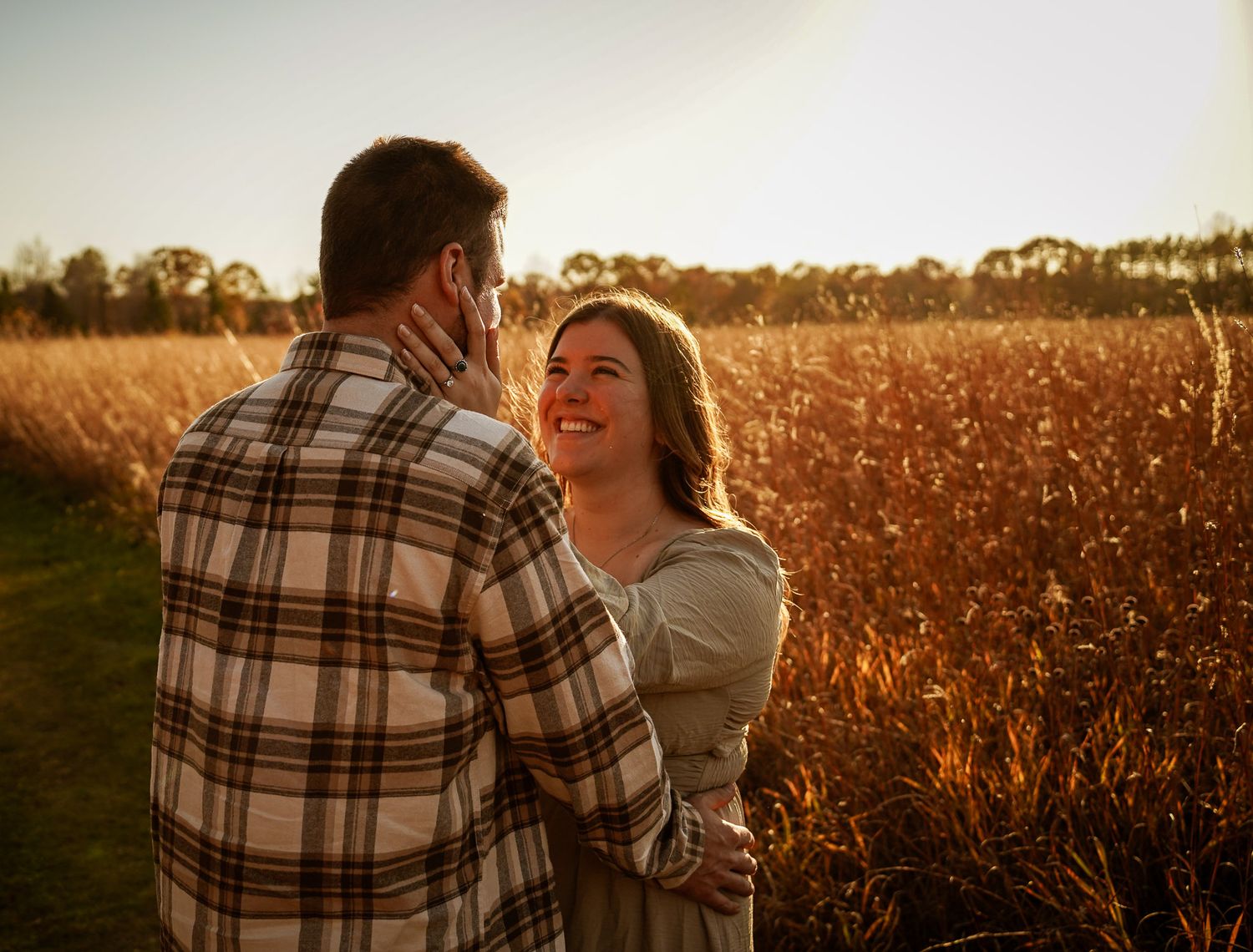 Wisconsin Couple and Engagement Photographer - Couple in a field in fall during an engagement session in Wisconsin during sunset.