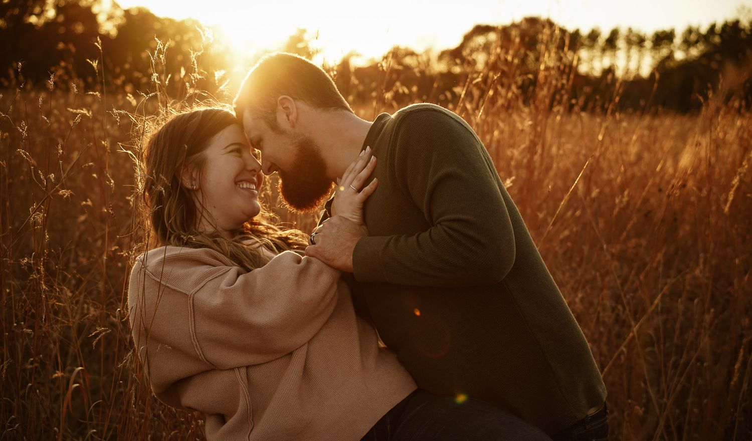 Wisconsin Couple and Engagement Photographer - Couple in a field in fall during an engagement session in Wisconsin during sunset.