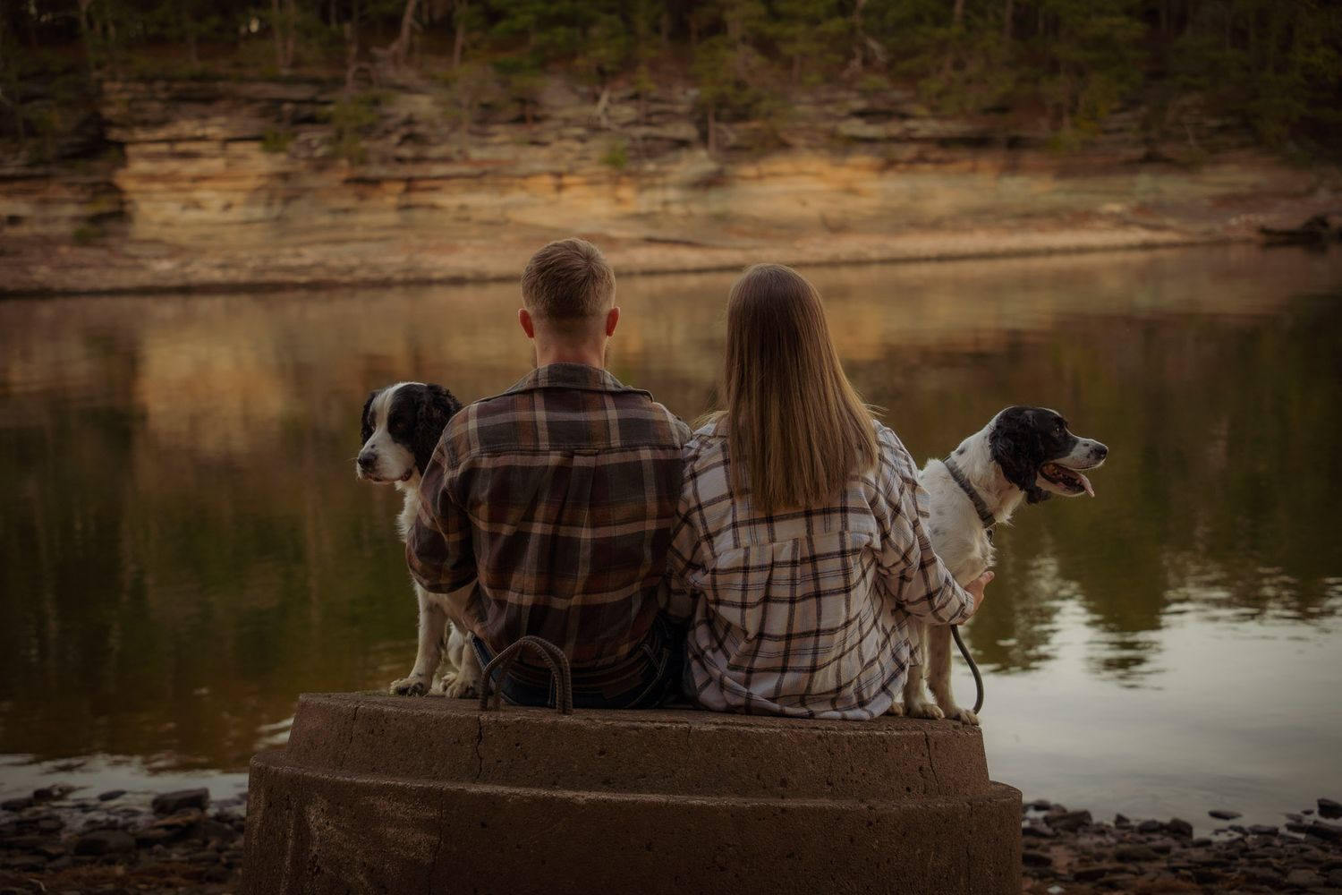 Wisconsin Couple and Engagement Photographer - Couple in plaid with two dogs on riverbank during engagement session in fall in Wisconsin.