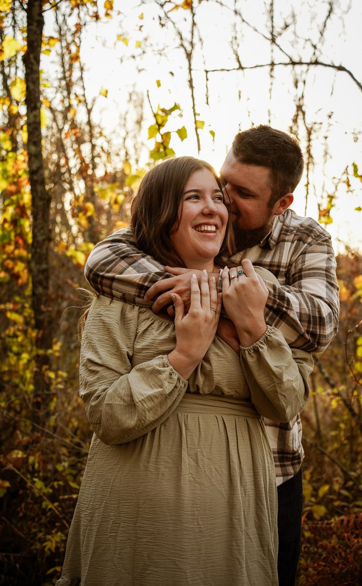 Wisconsin Couple and Engagement Photographer - Couple laughing in woods in fall during an engagement session during sunset in Wisconsin.