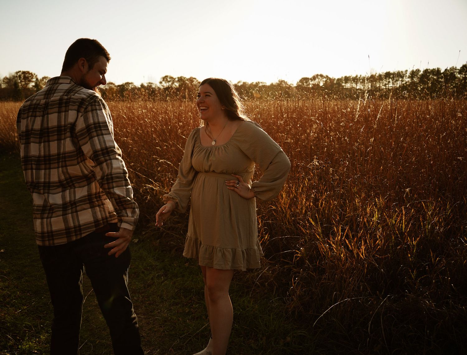 Wisconsin Couple and Engagement Photographer - Couple in a field in fall during an engagement session in Wisconsin during sunset.