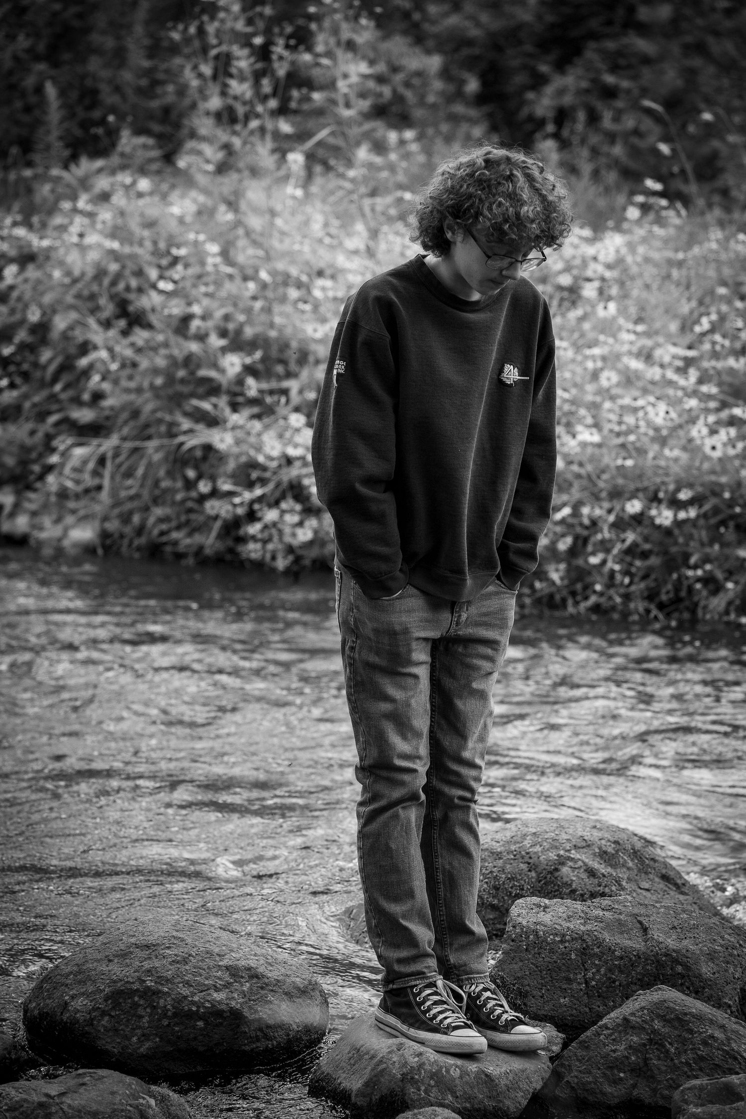 Wisconsin Senior and Portrait Photographer - Boy standing on a rock on a river in Wisconsin during a summer senior portrait session.