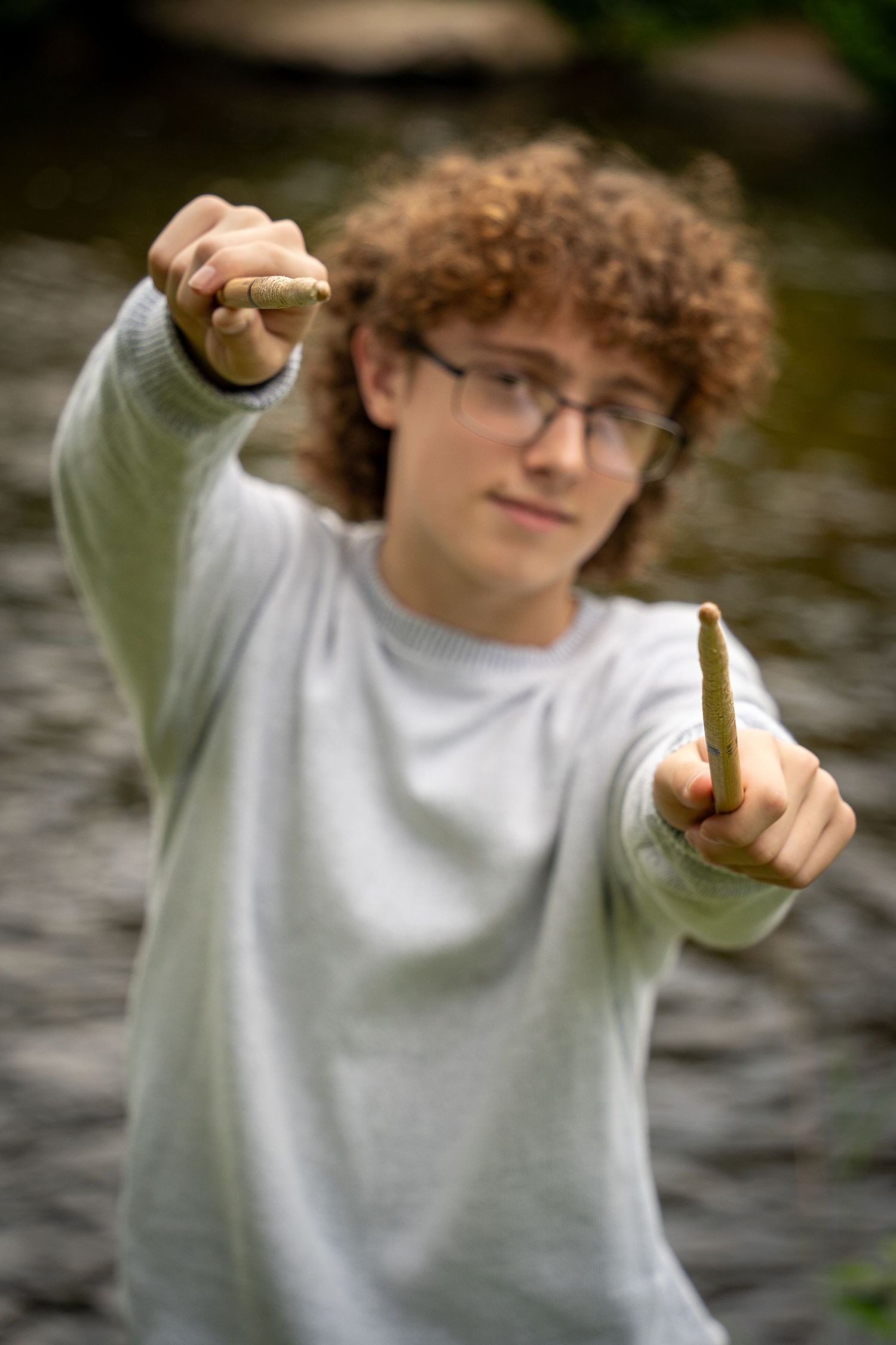 Wisconsin Senior and Portrait Photographer - Drummer senior boy smiling holding drumsticks in Wisconsin during a summer senior portrait.