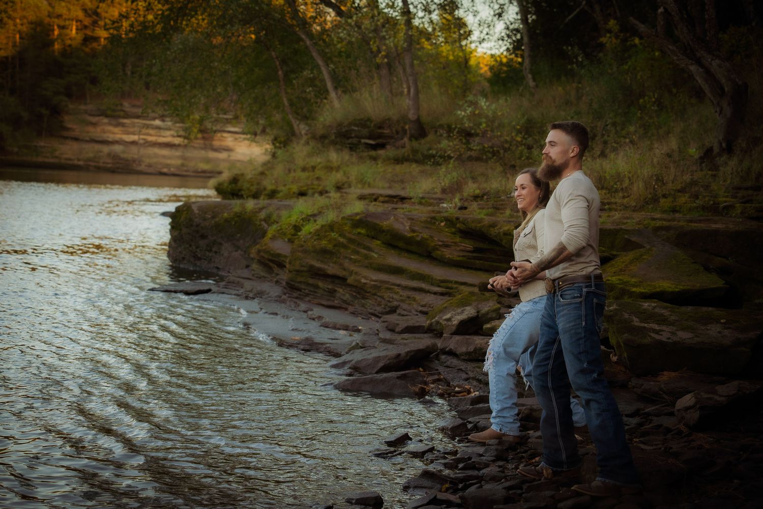 Wisconsin Couple and Engagement Photographer - Couple skipping rocks in fall during an engagement session in Wisconsin during sunset.