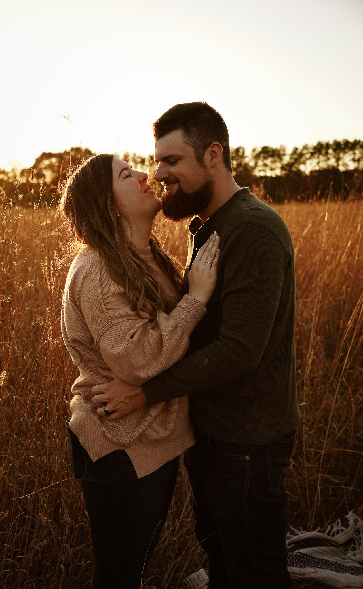 Wisconsin Couple and Engagement Photographer - Couple in a field in fall during an engagement session in Wisconsin during sunset.