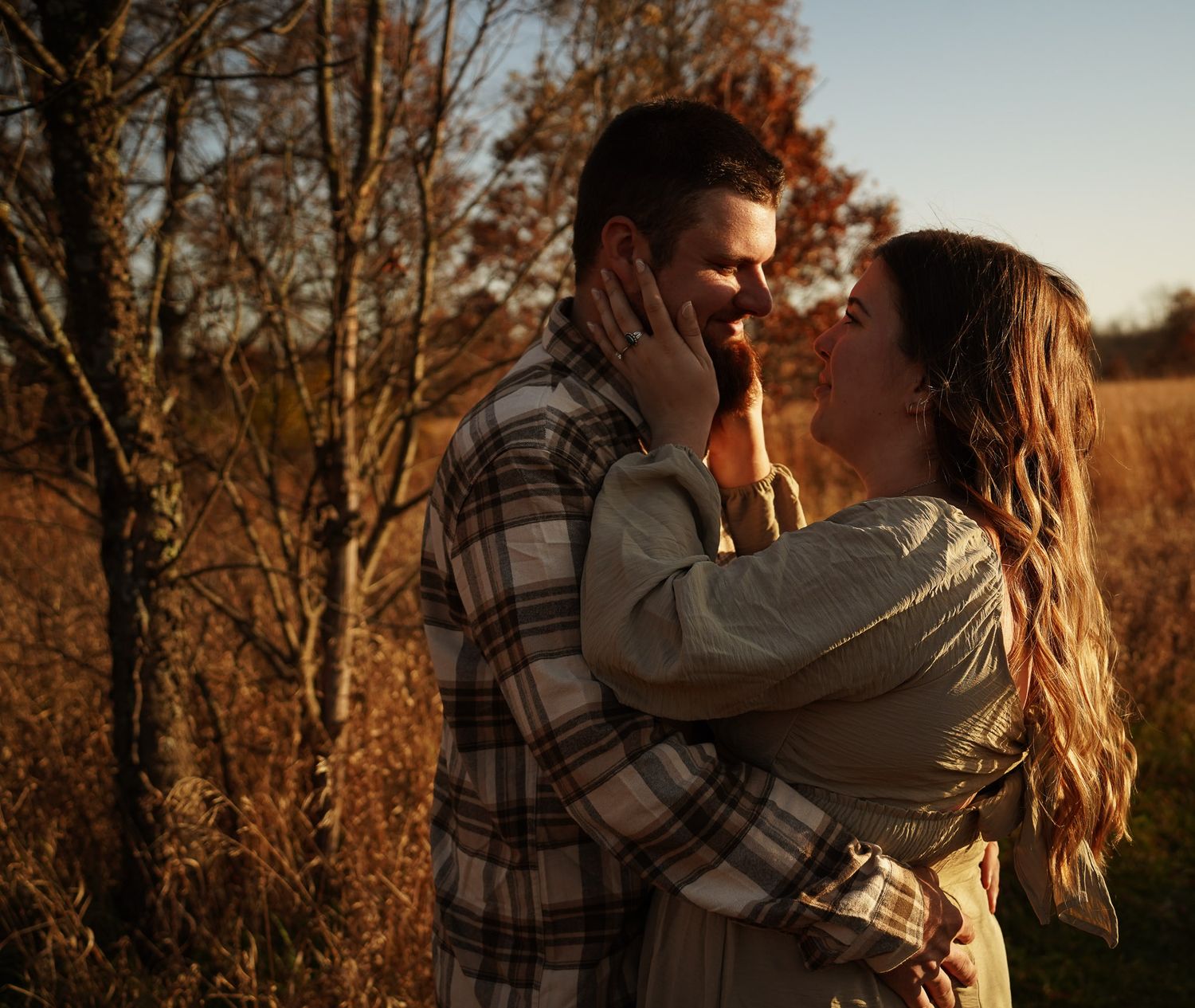 Wisconsin Couple and Engagement Photographer - Couple in a field in fall during an engagement session in Wisconsin during sunset.