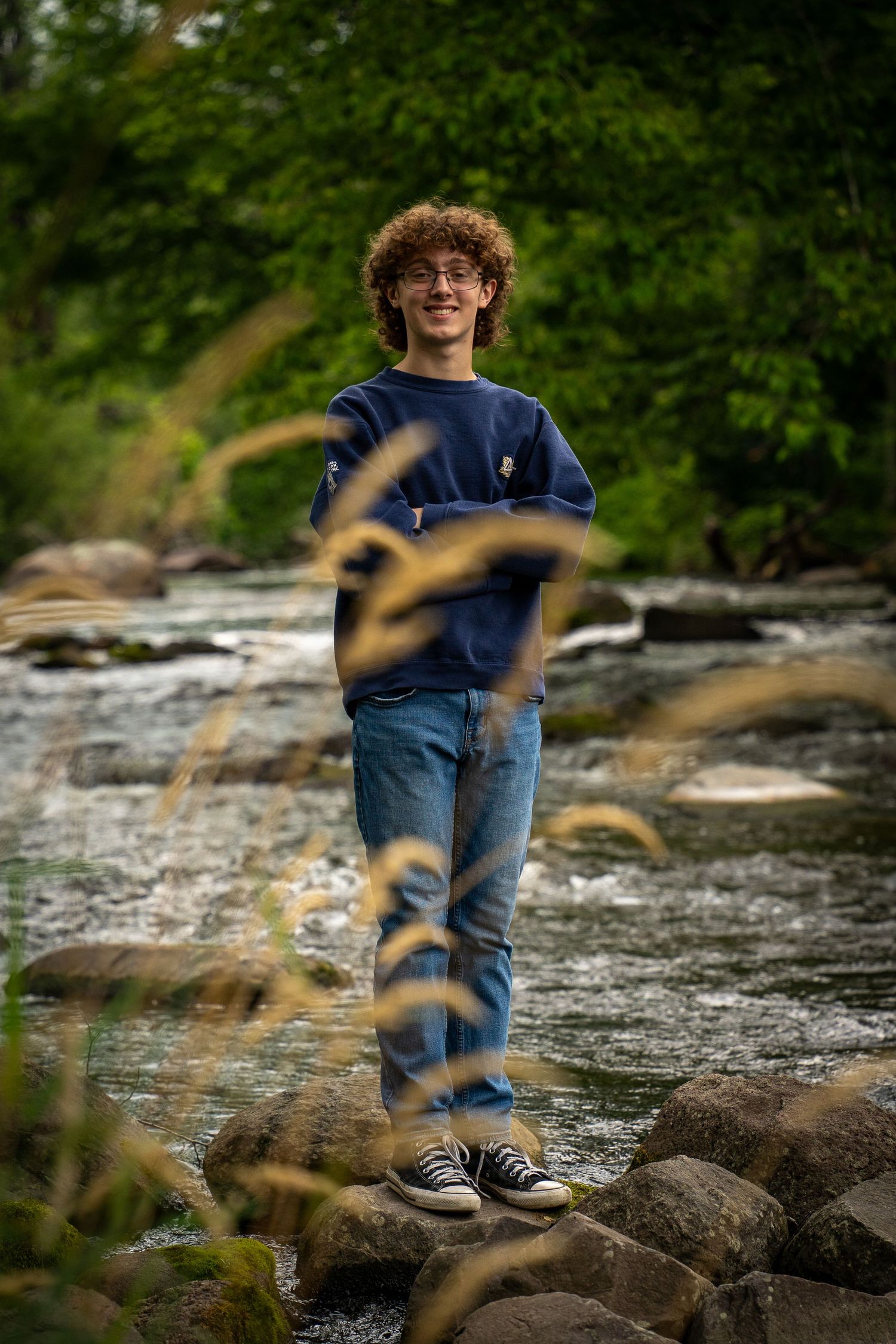 Wisconsin Senior and Portrait Photographer - Boy standing on a rock on a river in Wisconsin during a summer senior portrait session.