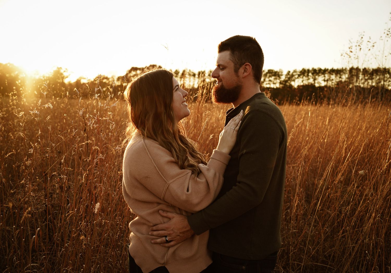 Wisconsin Couple and Engagement Photographer - Couple in a field in fall during an engagement session in Wisconsin during sunset.