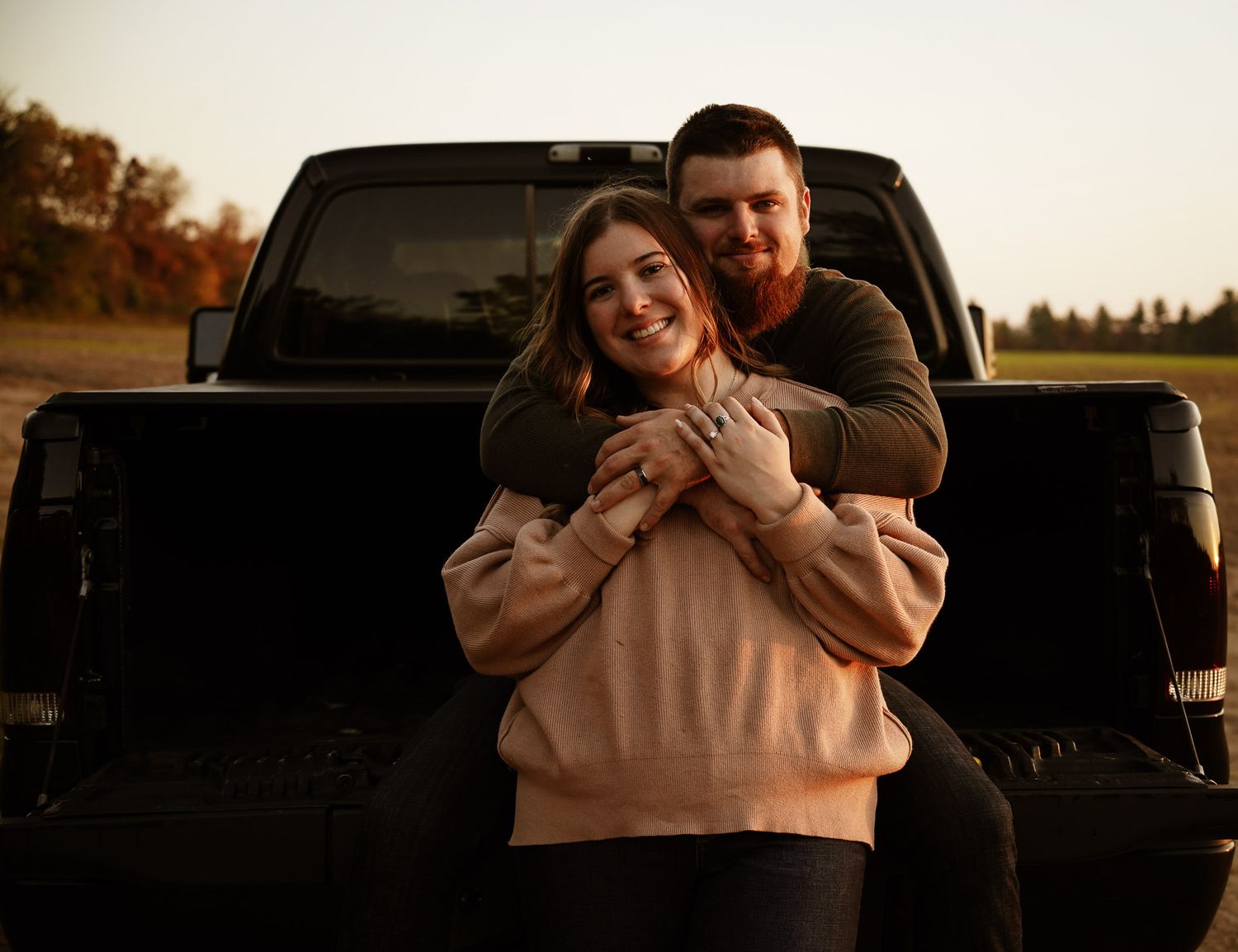 Wisconsin Couple and Engagement Photographer - Sunset photo of couple silhouette during engagement session with a trucks in a field.