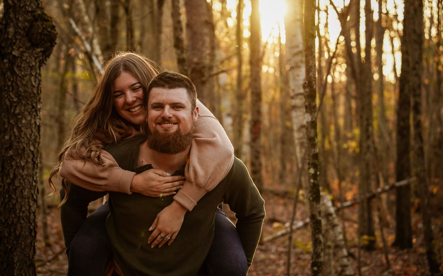 Wisconsin Couple and Engagement Photographer - Couple laughing in woods in fall during an engagement session during sunset in Wisconsin.