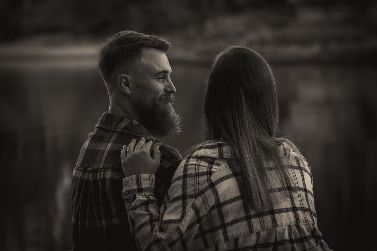 Wisconsin Couple and Engagement Photographer - Black and white couple on riverbank in Wisconsin in fall during engagement session.