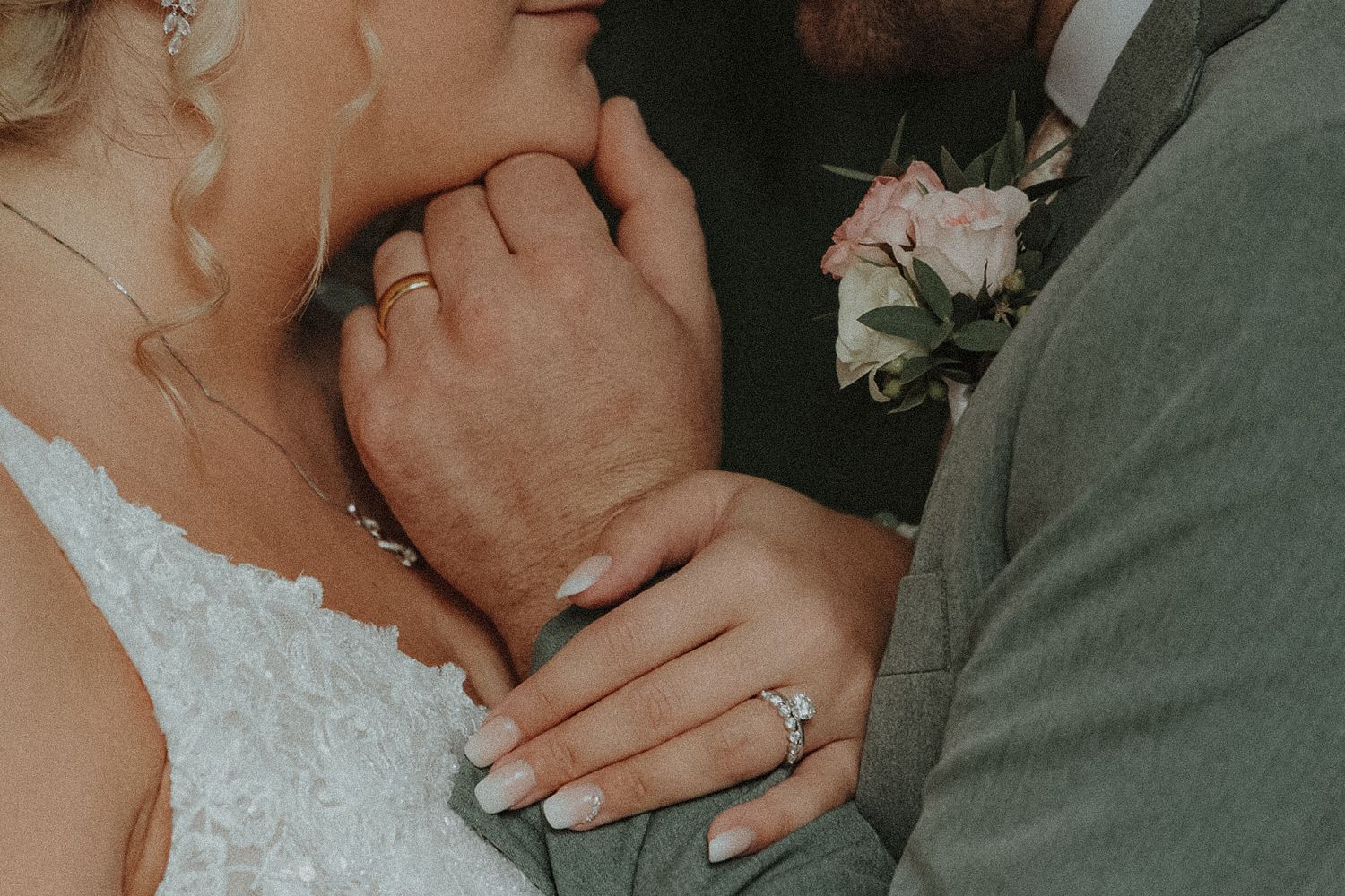 Close up of hands with wedding rings in warm lighting at Secrets Akumal Mexico Resort wedding