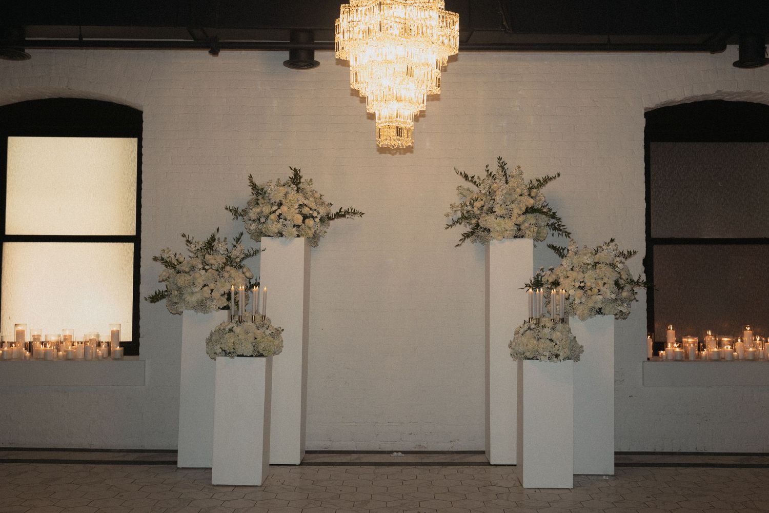 Elegant crystal chandelier hanging in a modern white event space at Le Venere wedding venue in Saint Paul Minnesota