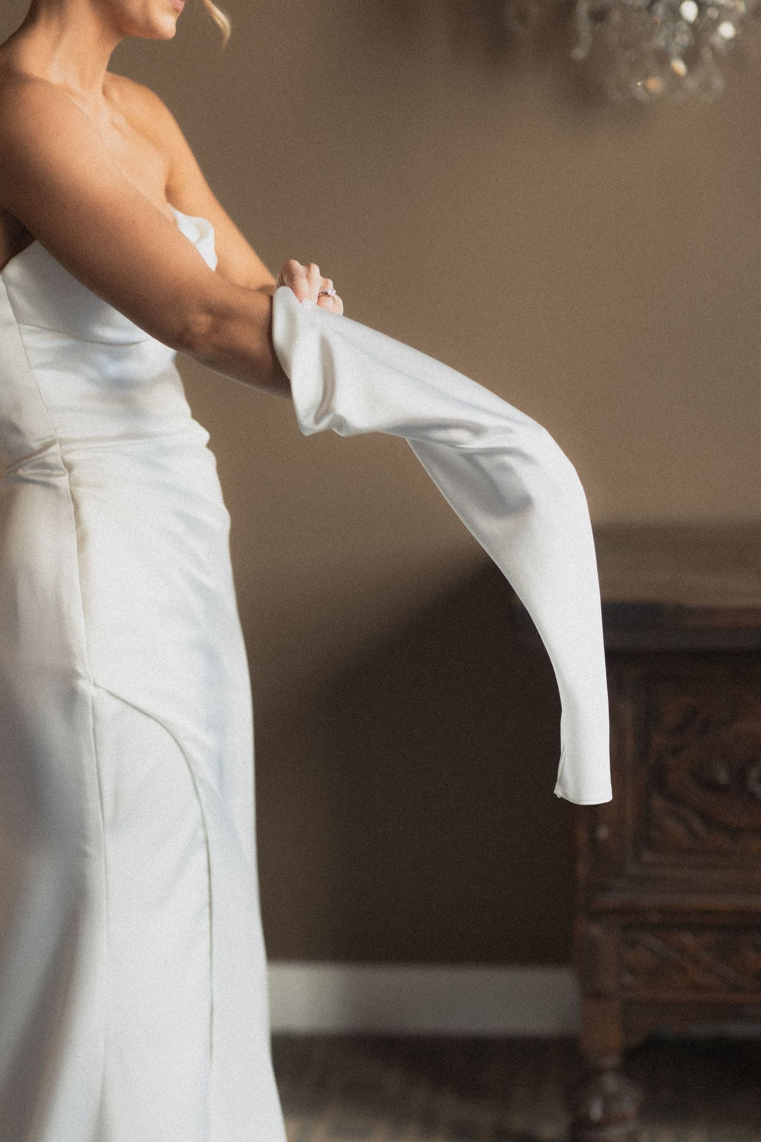A close-up of white bridal gloves and wedding dress details direct flash at Le Venere in Saint Paul Minnesota
