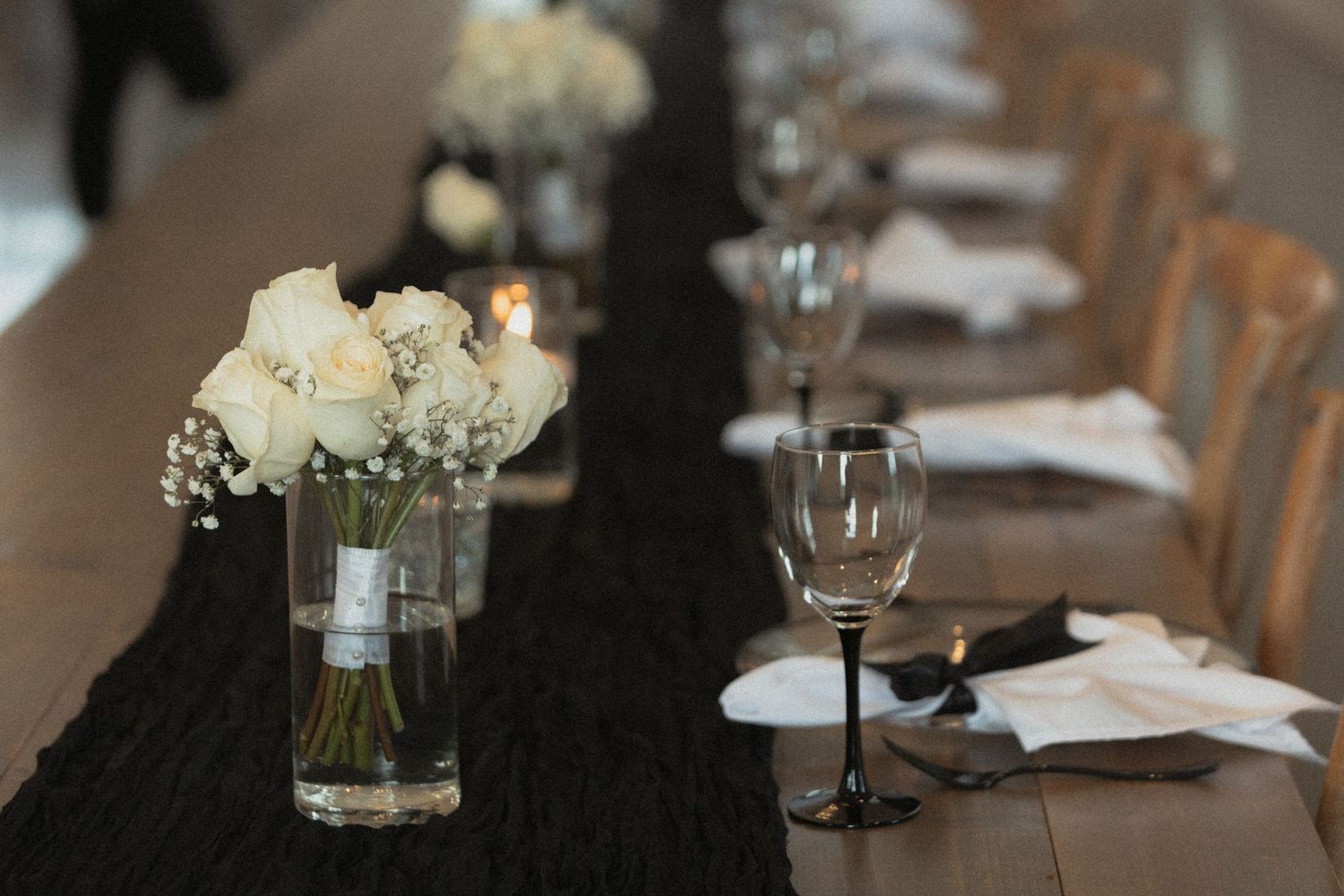 Elegant table settings with glassware and white floral centerpieces at Abella Wedding venue in Chisago City Minnesota
