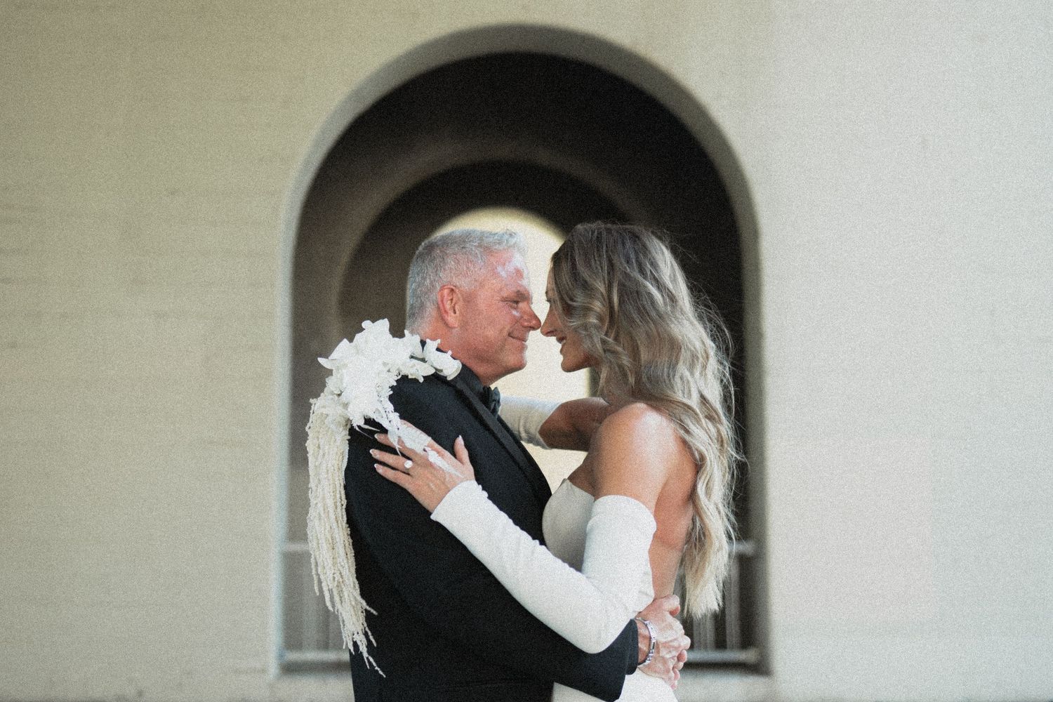 An elegant wedding moment captured under a classic archway Stone Arch Bridge in Minneapolis Minnesota Saint Anthony Main