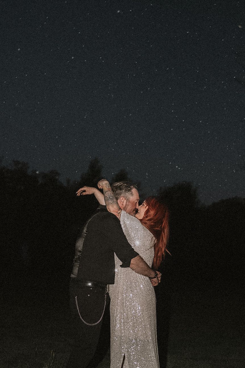 A romantic embrace under a starlit night sky in a sparkly wedding dress in Milaca Minnesota