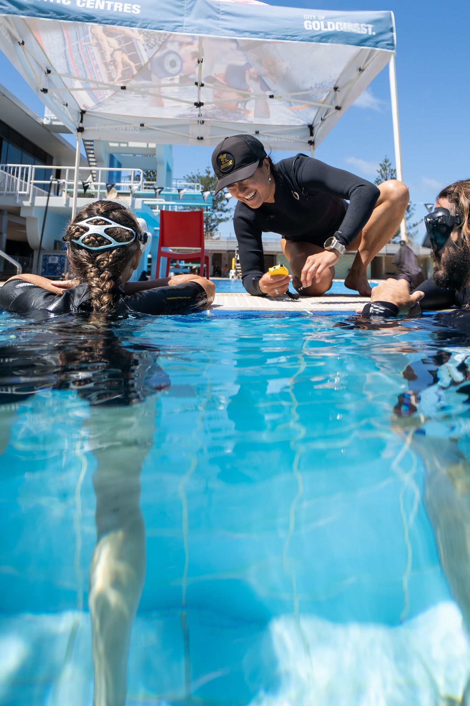 A split-view underwater photo shows scuba divers practicing skills in a bright blue swimming pool.